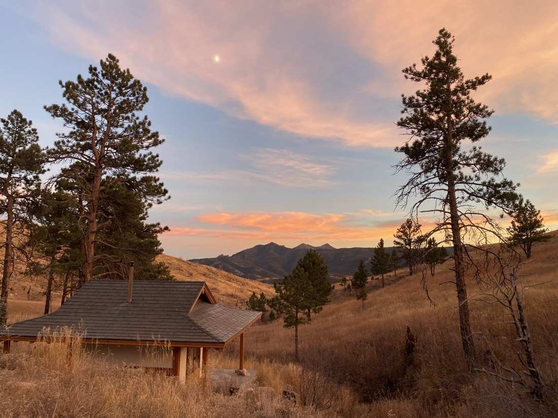 The teahouse at sunset beneath a rising moon and pink clouds