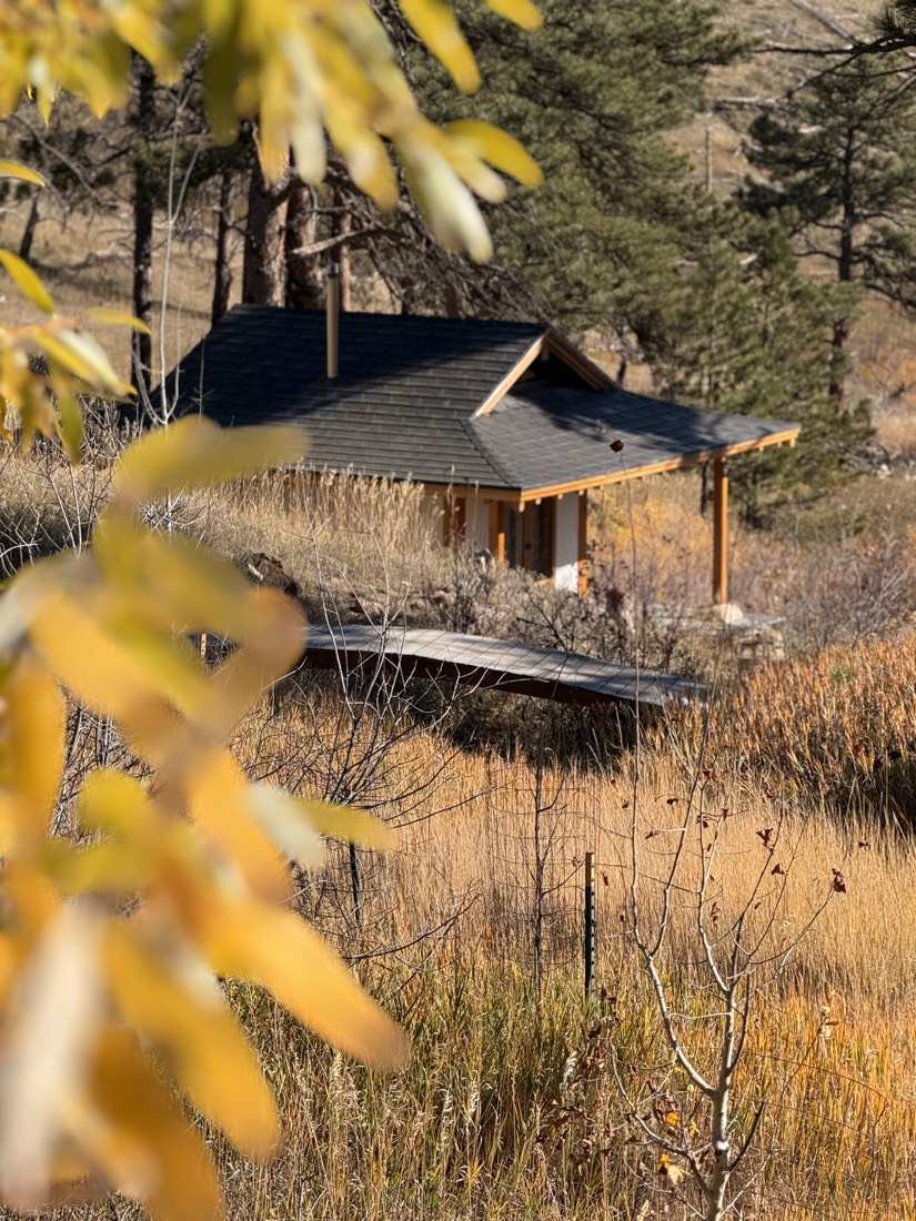 The teahouse and footbridge seen through a frame of golden aspen leaves