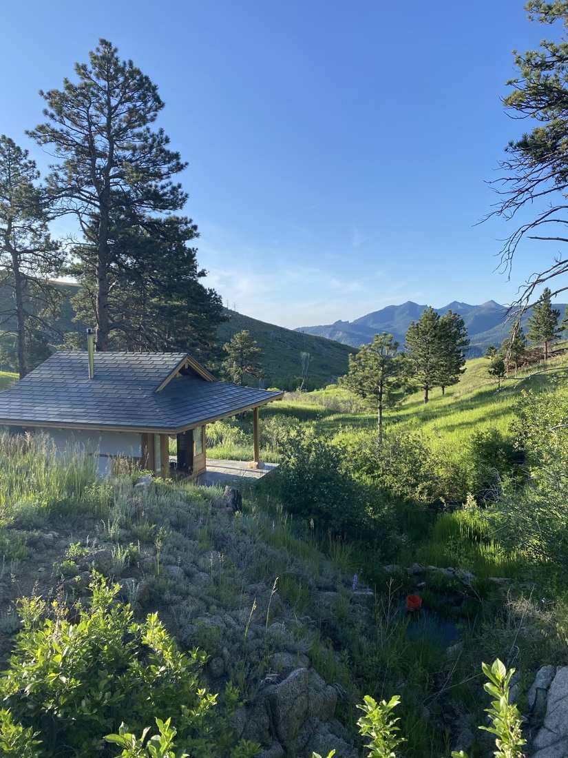 The teahouse in lush June green, peaks on the horizon
