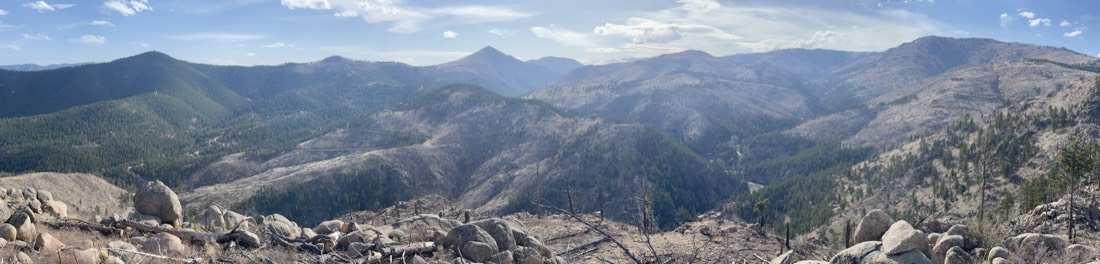 Summit panorama over Sunshine and Fourmile canyons with long mountain views