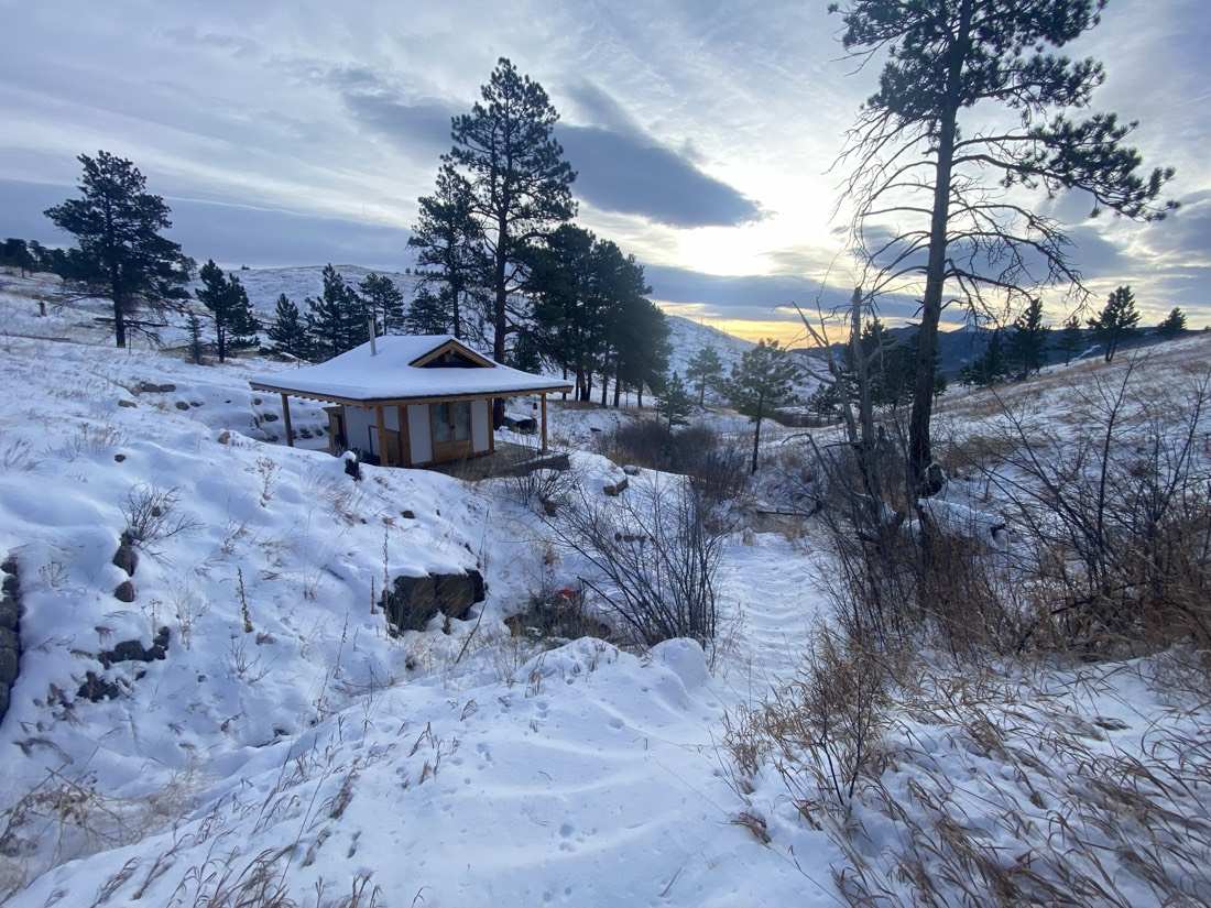 The teahouse in snow at dusk, the path winding down the drainage