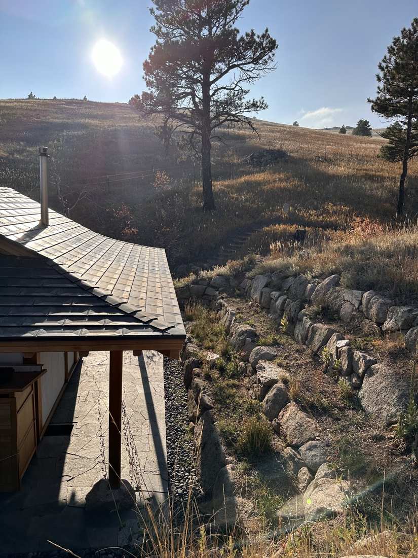 Roof shingles and stone terraces climbing the sunlit hillside